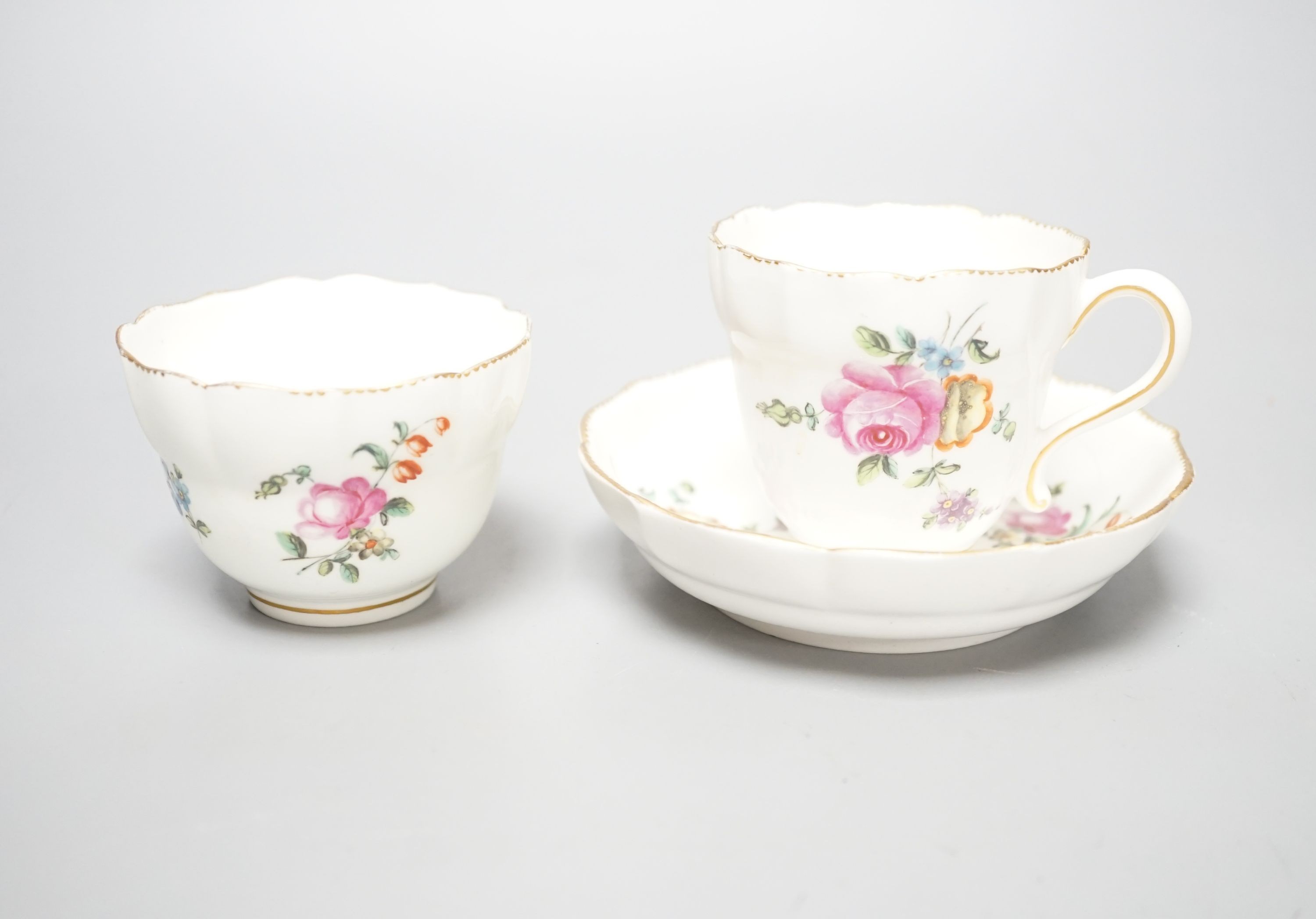 A Chelsea-Derby coffee cup, tea bowl and saucer painted with sprays and sprigs of flowers, c.1775, diameter 12cm